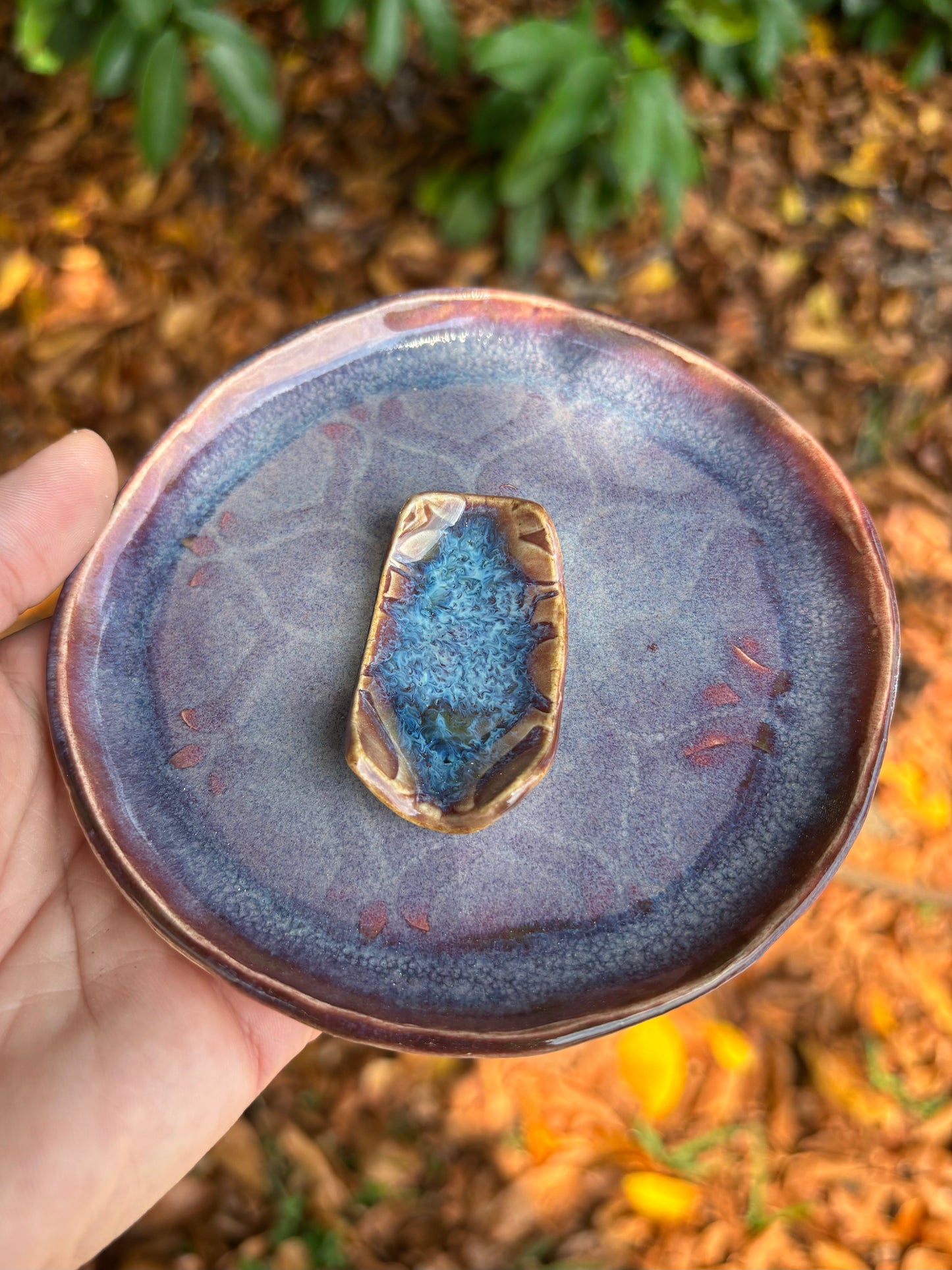 Photo of a purple ceramic plate and matching chopstick rest.