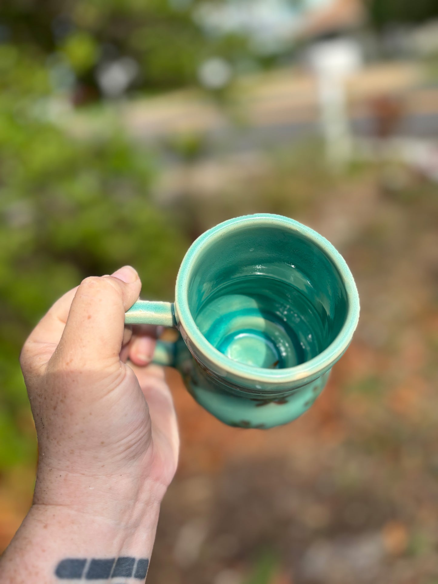 Photo of the inside of a large blue green pottery mug.